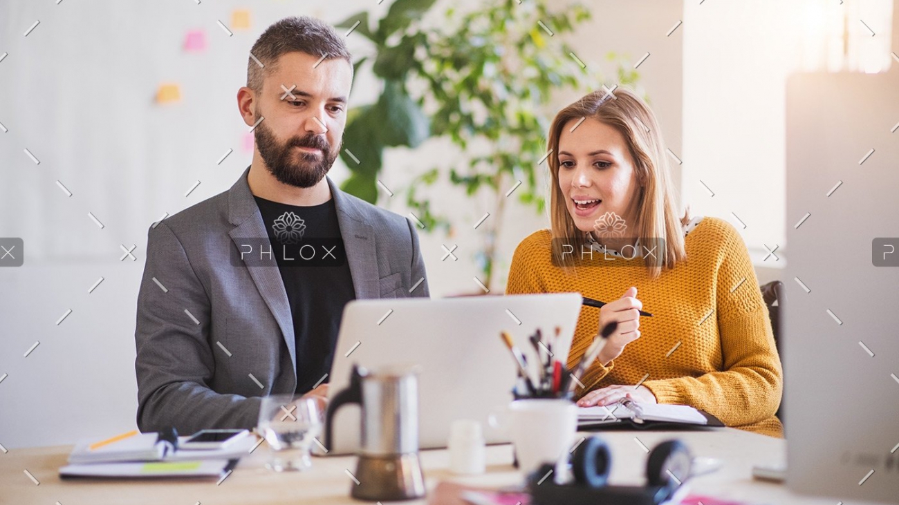 two-business-people-with-wheelchair-in-the-office-P7XLSBC
